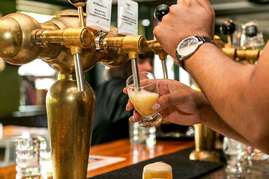 Amsterdam: Guided Craft Beer Brewery Bus Tour with Tastings - Finding the yellow-shirted guide at Overhoeksplein
